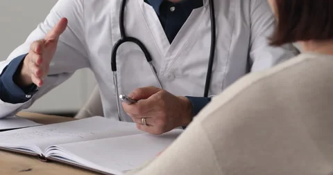 Close up young female doctor consulting older patient. Stock Footage