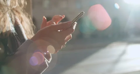 Close up of young female hands using phone, outdoors. 動画素材 86086765