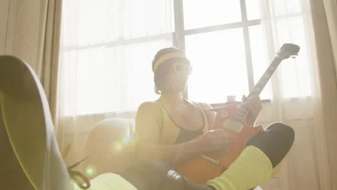 Close up of young funny hipster guy at home dressed in a vintage tight yellow Stock Footage 168297467