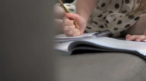 A close-up of a young girl doing homework Stock Footage 44117010