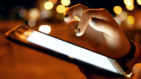 Close up of young girl Hands using tablet pc at the night city traffic. Stock Footage 76987007