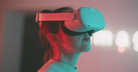 Close up of a young girl using the virtual reality glasses in neon light Stock Footage 201113692