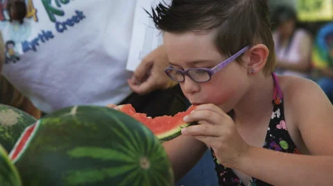 Close-up of a young girl in a watermelon eating contest Stock Footage