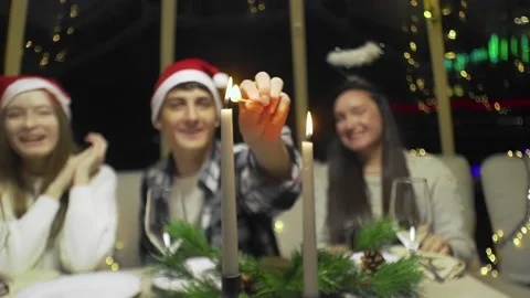 Close-up of a young guy lights candles. Video stock 220075928