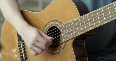 Close-up of a young guy playing a guitar. Stock Footage 130993412