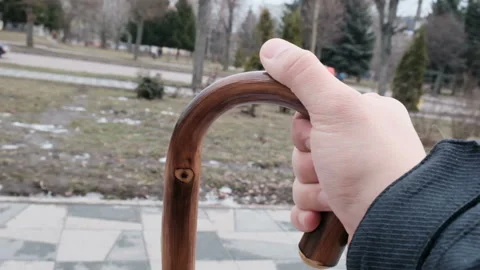Close up of young hands holding a cane Stock Footage 165974503