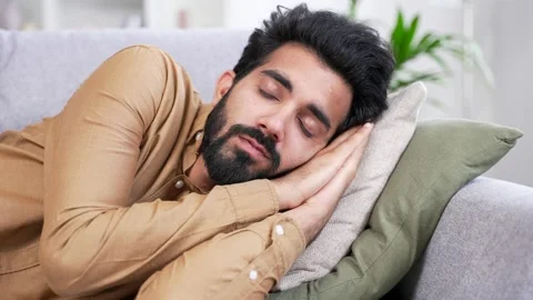 Close up of a young handsome bearded man sleeping during the day while lying on  Stock Footage 252216183