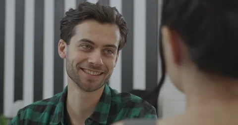 Close-up of a young handsome guy with green eyes who invites a girl to another 스톡 동영상 145438597