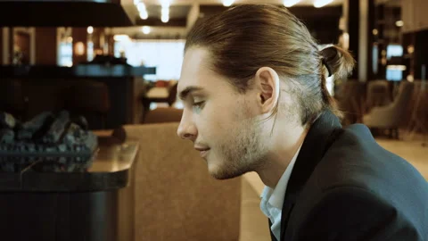 Close-up of young handsome man discussing business ideas at business meeting. 4K Video stock 89825335