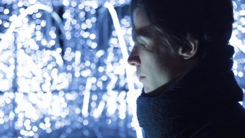 Close up of young handsome man using smartphone standing outdoors at night Stock Footage 83631976