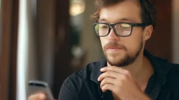 Close up on the young handsome man is using a smartphone. Stock-Footage 85524139