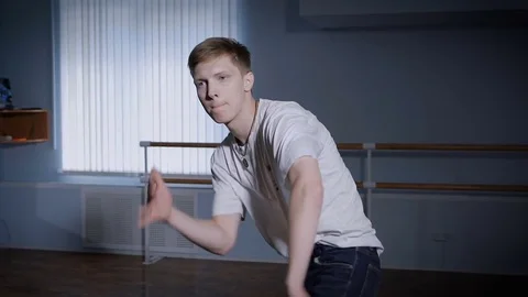Close up of young hip-hop dancer in black trousers and white shirt performing Stock Footage 70368615