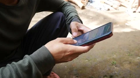 Close-up of young Indonesian man hand typing message. Stock-Footage 204079934