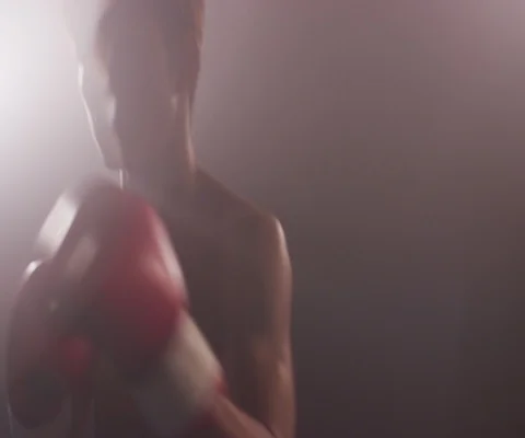 Close up of young Japanese man practising hitting and punching with red gloves Stock Footage 147051574