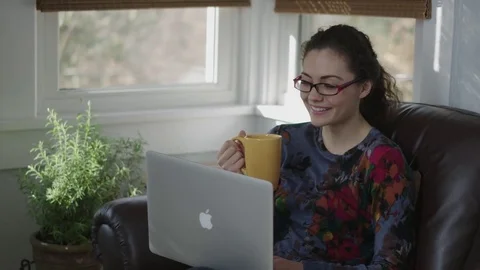 Close up of young lady using a laptop while camera tracks Stock Footage 70809016