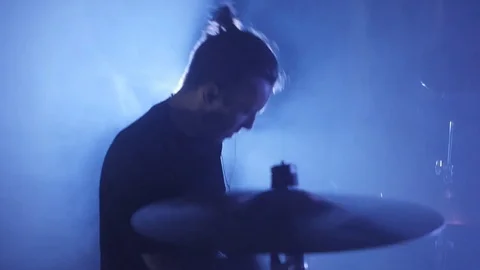 Close-up of a young male drummer playing on a drum set. Music video punk, heavy Stock Footage