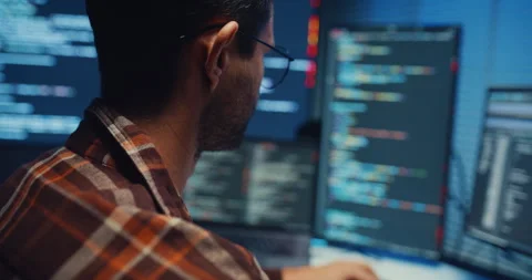 Close up young Male programmer hands typing on keyboard in office at night. Stockbeeldmateriaal 344047821
