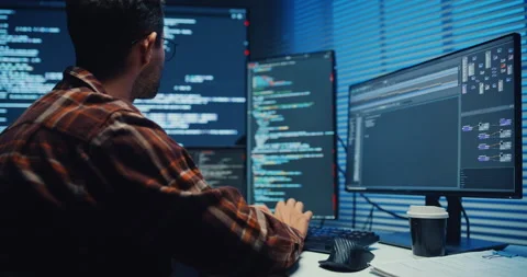 Close up young Male programmer hands typing on keyboard in office at night. Vidéo 344047906
