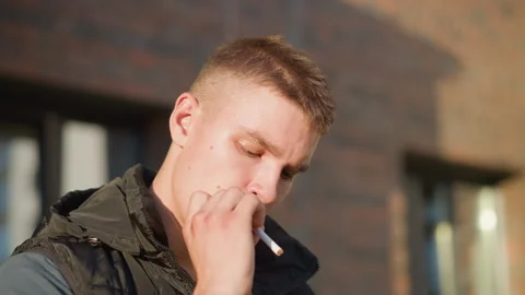 Close up of young man about to smoke changes mind throws cigarette away Stock Footage 307066588