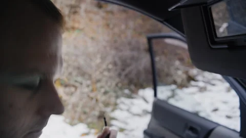 Close-Up of Young Man Applying Eye Makeup in Car 库存影片 302211314