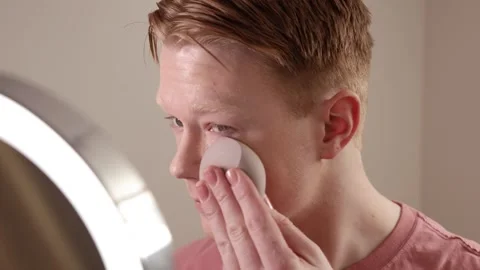A Close-Up Of A Young Man Applying Foundation Skincare Makeup Routine Stock Footage 309358843