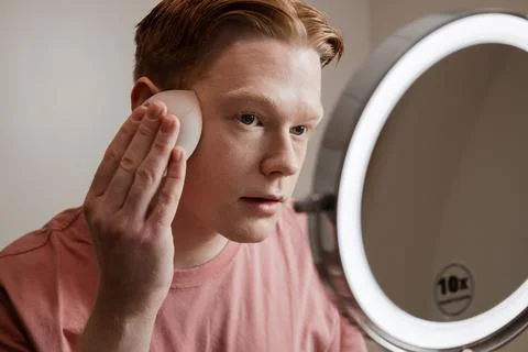 A Close-up Of A Young Man Applying Foundation Skincare Makeup Routine Stock Photos