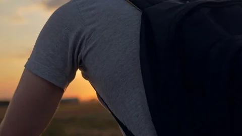 Close-up of young man with backpack riding a bicycle. Stock Footage 78647422