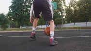 Close Up Of Young Man On Basketball Court Dribbling With Ball. Stock Footage