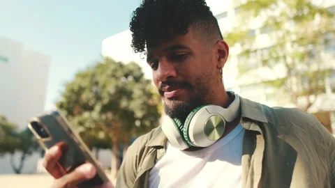 Close up, young man with beard wearing an olive-colored shirt with headphones Stock Footage 226854922