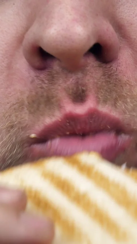 Close-up young Man biting a sandwich with great appetite. Very hungry man Stock Footage 304281632