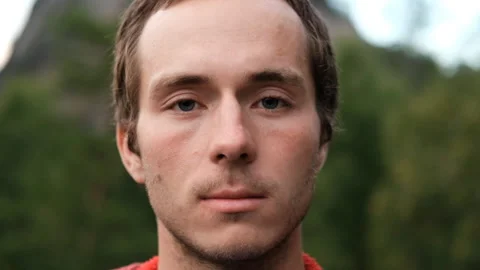 Close-up of a young man with bristles opens his eyes. Stock Footage 147400585