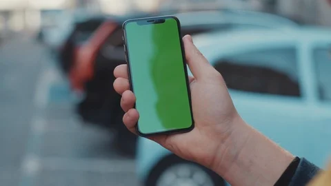 Close-up of young man browsing internet content on vertical mock-up greenscreen Stock Footage 117425858