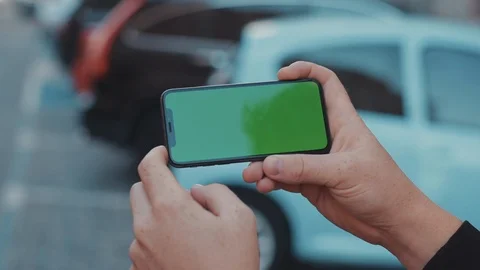 Close-up of young man browsing internet application on horizontal mobile phone Stock Footage 117426520