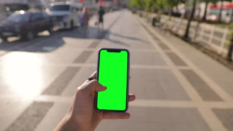 Close-up young man browsing social network in iPhone 11 smartphone green mock-up Stock Footage 154336236