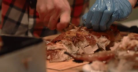 Close Up of Young Man Carving a Chunk of Turkey in the Kitchen Stock Footage 83488197