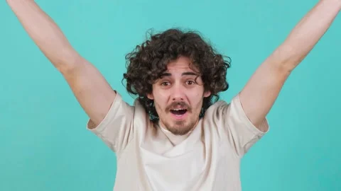Close up young man celebrating surprised and amazed for success with arms raised Video stock 155650698