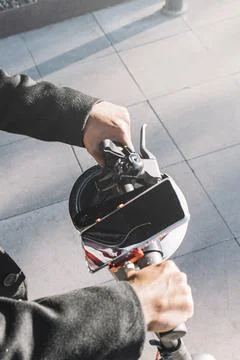 Close up of a young man in coat using modern and eco transport in the city Stock Photos