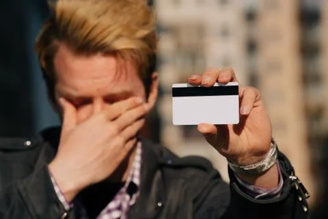 A close-up of a young man cries, the concept of credit card theft. stole cash Stock Photos