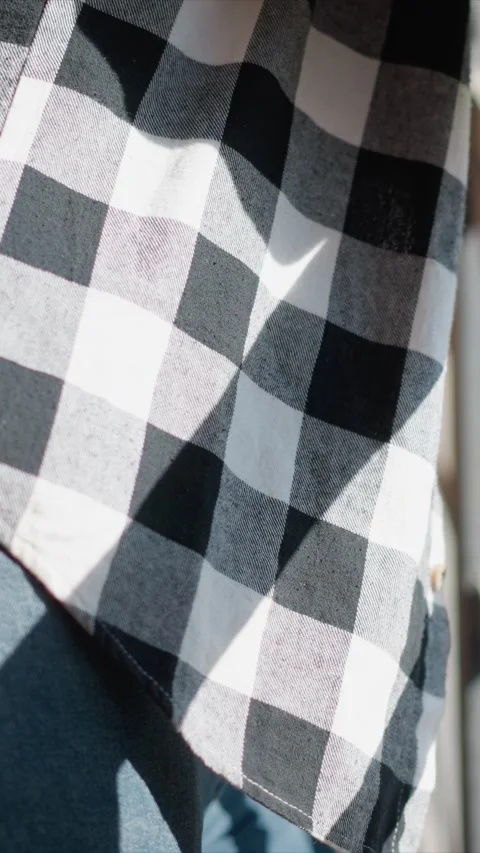 Close up of young man in dark blue jeans and black white checkered shirt Stock Footage 345050708