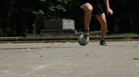 Close up of Young Man Demonstrating Footwork by Dribbling Soccer Ball Stock Footage 51344017