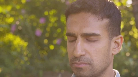 Close up young man does yoga position tree to prayer. - Slow Motion - shot on Stock Footage 125166515