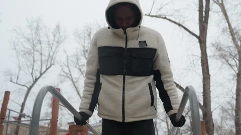 Close-Up of Young Man Doing Push-Ups on Outdoor Parallel Bars in Snowy Weather Stock Footage 305628910