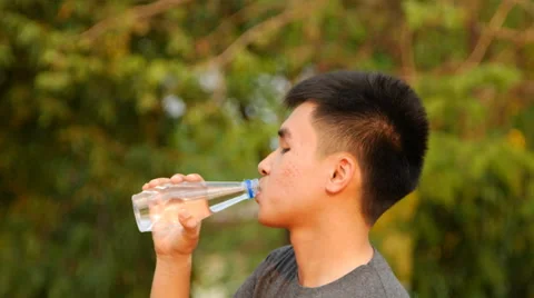 Close-up of a young man drinking water from a bottle outside Stock-Footage 62008208