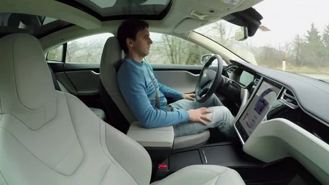 CLOSE UP: Young man driving in autosteering autonomous autopilot driverless car Stock Footage 72880968