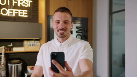 Close-up of a young man during a video conference on the phone with colleagues Stock Footage 246050986