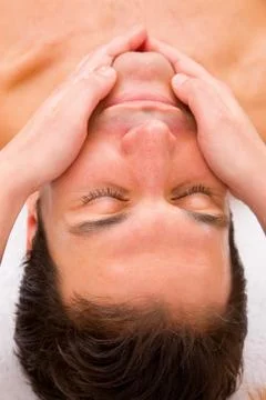 Close-up of young man getting face massage Stock Photos