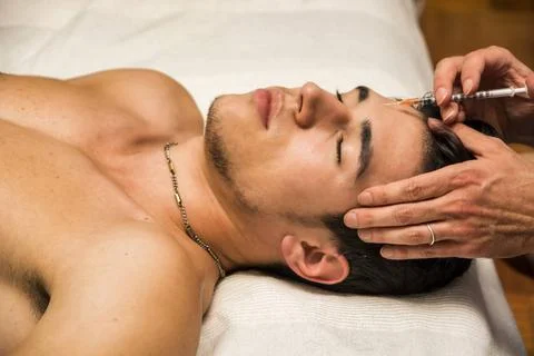 Close-up of young man getting injection of botox Close-up of young man get... Stock Photos