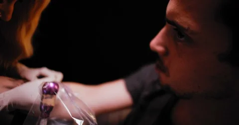 Close up of a young man getting a tattoo in a professional tattoo studio. Stock Footage 125765235