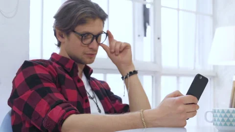 Close Up Of A Young Man With Glasses Sitting On A Chair Stock Footage 137093871