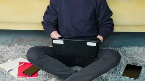 Close up of an young man hands that is browsing at his laptop, working at the Stock Footage 154307976